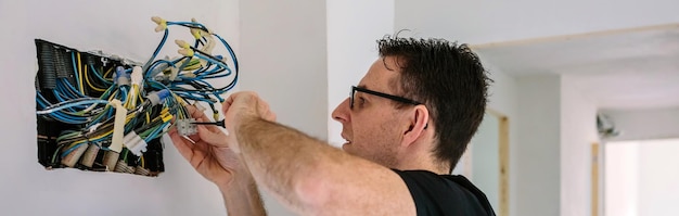 electrician working electrical installation house
